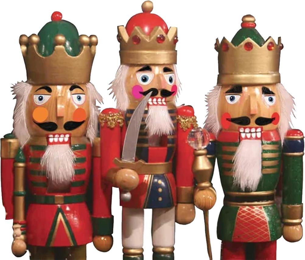 Three wooden nutcracker figures dressed in colorful uniforms and crowns are standing side by side, with one holding a sword.
