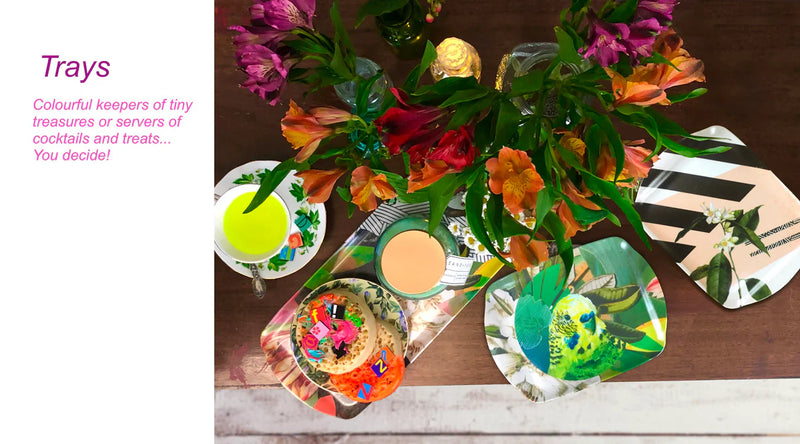 A wooden table with vibrant floral arrangements, decorative trays featuring birds and flowers, a teacup, and a plate with a colorful dessert. Text on the left describes the use of trays.