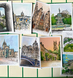 The Essential Edinburgh Mini Print Set features 15 A6 original drawings of European architecture and cityscapes—perfect as Edinburgh art prints or unique Scotland gifts—arranged on a gridded background.