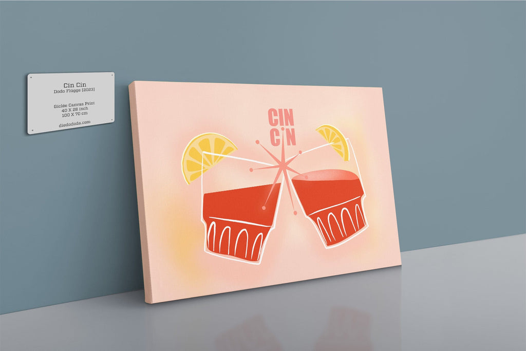 The Shromps Cin Cin Matte Canvas Print shows two red cocktails, lemon slices, and "Cin Cin" text, adding nostalgic holiday flair to a gray wall when displayed next to a business card.