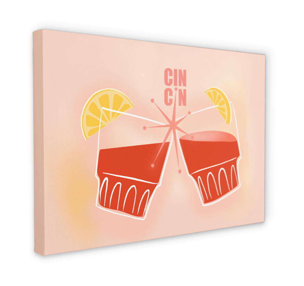 The Cin Cin Matte Canvas Print by Hôtel Dodo showcases two stylized glasses of red beverage with lemon slices, with the text "CIN CIN" above. The light peach background enhances the zesty retro print vibe, reminiscent of Hôtel Dodo's tropical foliage decor.