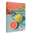 The Mellow Pomelo Giclée Canvas Print by Hôtel Dodo portrays a still-life scene with a sliced grapefruit, a whole grapefruit, and a blood orange on a blue table. Some leaves and a piece of paper are also included, set against an orange gradient background.