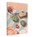 Illustration of a table with wine, artichokes, figs, baked Camembert, cheese, and an afternoon menu on a pastel-striped tablecloth from the "Figgy Cheese And 'Chokes Giclée Canvas Print" by Hôtel Dodo.