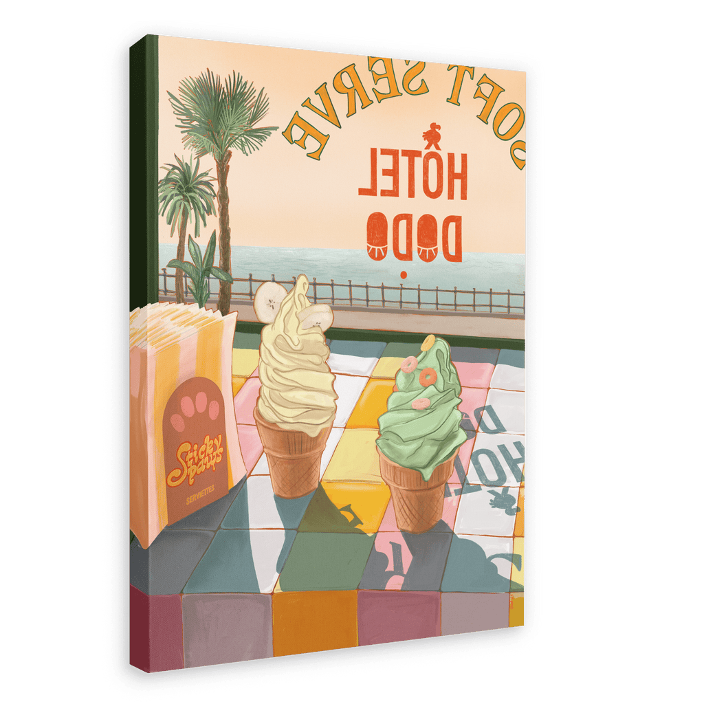 Vibrant canvas print featuring two ice cream cones in front of a seaside view, with "Hôtel Dodo" visible in the background. The tropical foliage adds a lush vibe to the scene. The giclée print, titled "Soft Serve," includes a stack of what appears to be postcards.