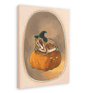 The Grumpy Spiced Pumpkin Giclée Canvas Print by Kitsch Kanaveral features an illustration of a witchy rain frog wearing a witch hat, sitting on a carved pumpkin with a grumpy face. The image captures autumn vibes and is set within an ornate oval frame.