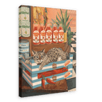 A Bodega Cat Giclée Canvas Print from Hôtel Dodo depicts a cat nestled in a striped crate, surrounded by vegetables, tomato juice bottles, and canned food in a grocery store setting.