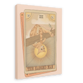 Tarot Cats’ “The Hanged Man Canvas Print” features a tarot card illustration of a cat hanging upside down by its tail from a branch, with sun rays in the background.