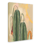 The Saguaro Sundown Giclée Canvas Print by Heat Flares showcases two tall, green cacti adorned with small flowers, set against a pastel background with abstract shapes.