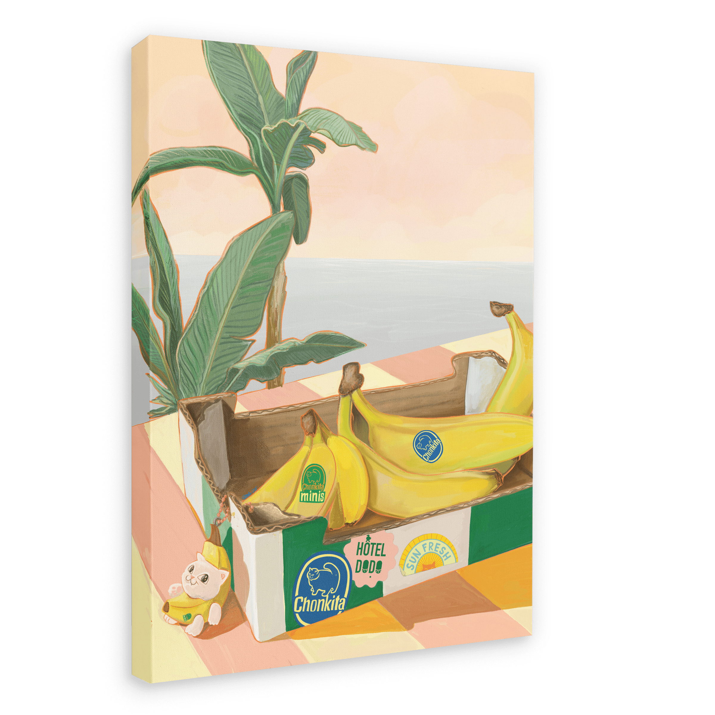 A vibrant Chonkita Bananas Giclée Canvas Print by Hôtel Dodo features bananas nestled in a cardboard box atop a checkered surface, accompanied by a small teddy bear, lush tropical plant, and the ocean beyond—capturing the whimsical charm of Hôtel Dodo, where even a banana cat may stop by.