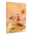 The L'Aperitivo Leopardo Giclée Canvas Print by Hôtel Dodo captures the essence of an Indian summer picnic, featuring a table with halved papayas, a bowl of strawberries, a bottle of Topo Chico, and a glass of iced tea on a striped tablecloth.