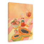 The L'Aperitivo Leopardo Giclée Canvas Print by Hôtel Dodo captures the essence of an Indian summer picnic, featuring a table with halved papayas, a bowl of strawberries, a bottle of Topo Chico, and a glass of iced tea on a striped tablecloth.