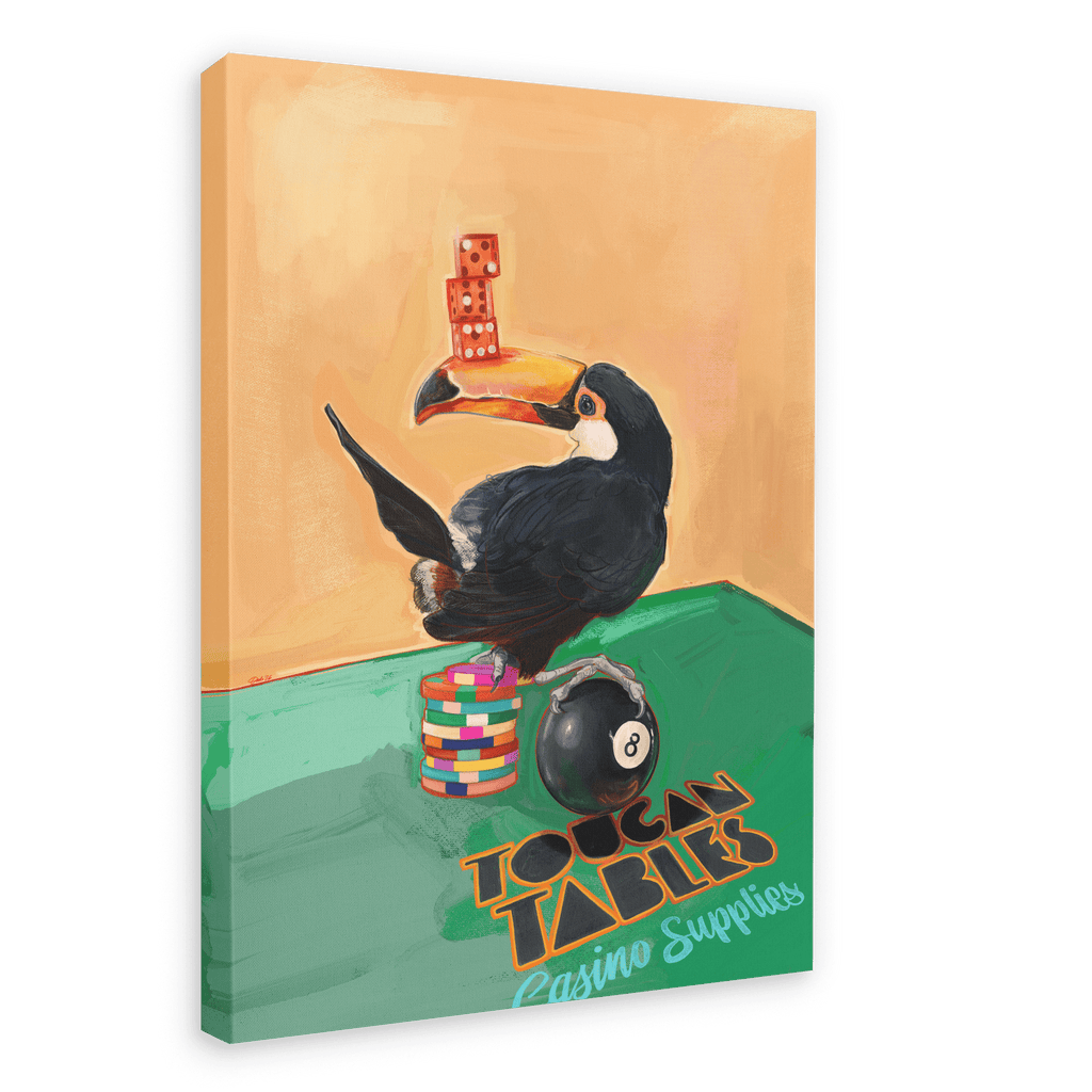 A toucan perches on a stack of poker chips, balancing dice on its beak and sitting next to an 8-ball in this Hôtel Dodo “Toucan Tables Giclée Canvas Print.”.