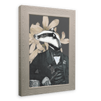 Introducing the “Badger In A Suit Canvas Print” by Animals In Suits—a striking collage art piece featuring an anthropomorphic badger dressed in a dapper suit and holding a cane, set against bold vintage botanical illustrations. This framed print makes a captivating addition to any space.