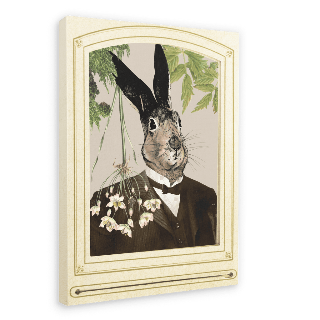 The Hare In A Suit Canvas Print by Animals In Suits features a portrait of Mister Hare, a rabbit with black-tipped ears dressed in a dark suit, posed before cascading flowers and lush greenery crafted from vintage botanical illustrations, all elegantly framed with an ornate cream border.