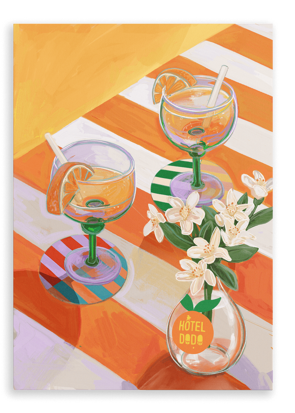 Two orange sodas—garnished with fresh slices and straws—rest on a striped table curated with elegant place settings, accompanied by a small white vase labeled “Hôtel Dodo,” beneath the vibrant A L’Orange Giclée Canvas Print from Hôtel Dodo.
