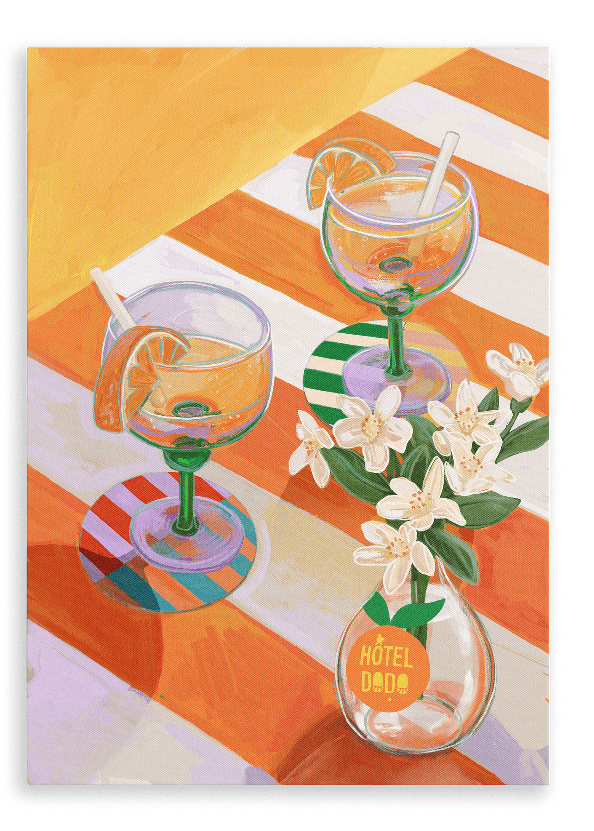 Two orange sodas—garnished with fresh slices and straws—rest on a striped table curated with elegant place settings, accompanied by a small white vase labeled “Hôtel Dodo,” beneath the vibrant A L’Orange Giclée Canvas Print from Hôtel Dodo.