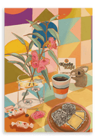 A table adorned with eucalyptus leaves, candy, a glass of water, a cup of coffee, scrumptious Lamington cake, a Koala Kafé card, and a toy koala is set against the vibrant geometric backdrop of the Hôtel Dodo “Koala Kafé” Giclée Canvas Print—radiating retro Australiana charm.