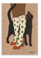Beauty and the Beastie’s "Encounters of the Purred Kind I" Matte Canvas Print features a whimsical scene of a black cat rubbing against someone in green polka dot socks and orange heels—a charming moment for cat lovers.