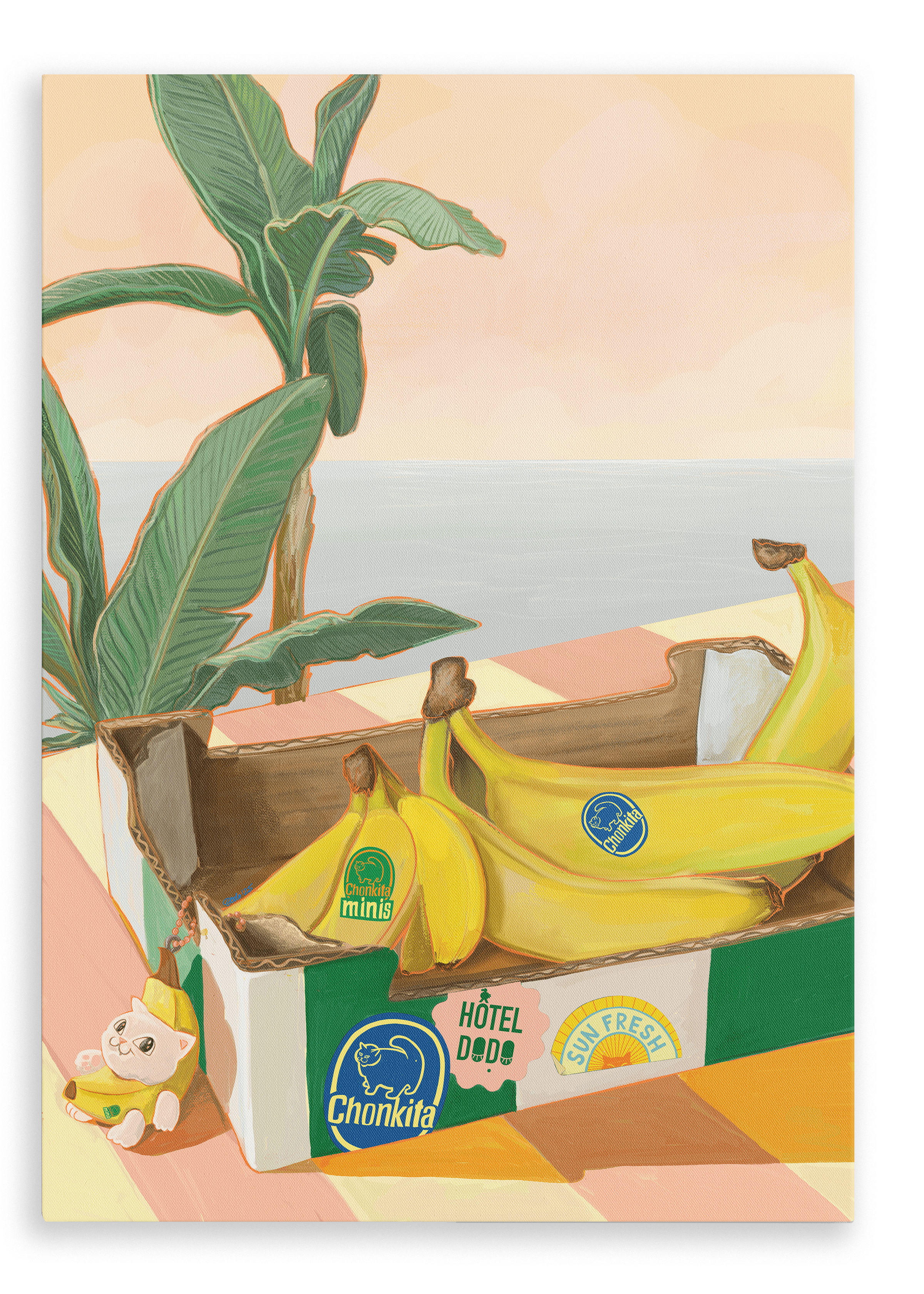A Chonkita Bananas Giclée Canvas Print by Hôtel Dodo—featuring a lovable banana cat cozily nestled in its peel—rests on a checkered table beside a plant, with an assortment of bananas adorned with colorful stickers and a small figurine lounging nearby.
