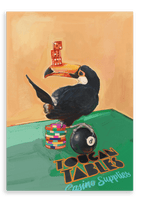 A toucan stands on poker chips and an eight ball, balancing red dice on its beak, with “Toucan Tables Casino Supplies” text on a green table surface in this Toucan Tables Giclée Canvas Print by Hôtel Dodo.