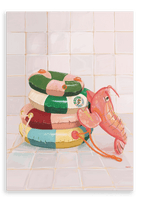 Three vibrant pool floats—including a pink elephant-shaped float and brightly striped rings—are stacked against a tiled wall on a white tiled floor, creating a playful scene evocative of Hôtel Dodo’s Platypus Pool Pals Giclée Canvas Print and classic inflatable pool rings.