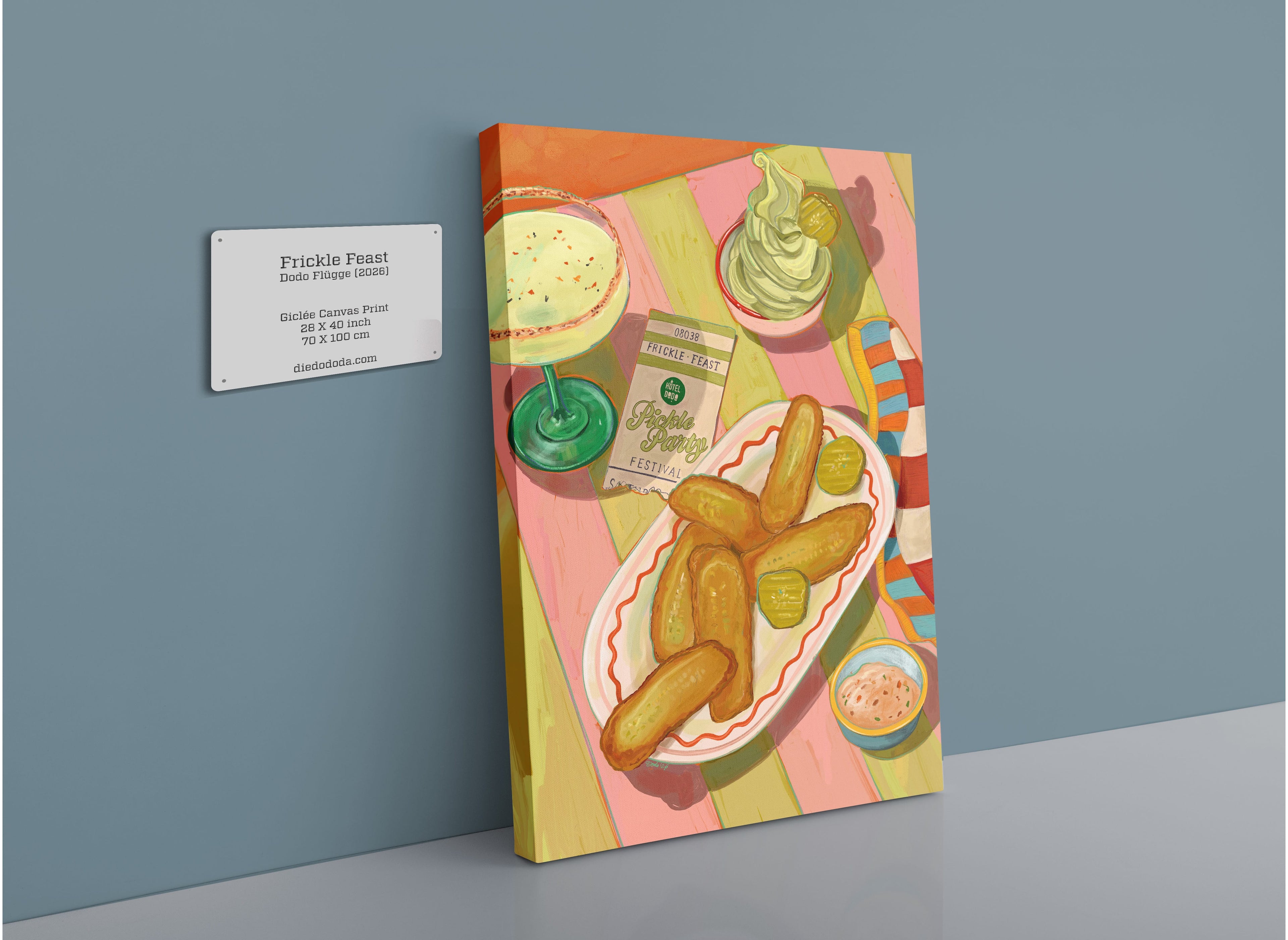 A vibrant giclée canvas print from Hôtel Dodo, titled “Frickle Feast,” showcases a painting of fried pickles, sauces, a drink, and dessert—capturing the lively essence of the Pickle Festival—displayed on the wall with a title plaque.