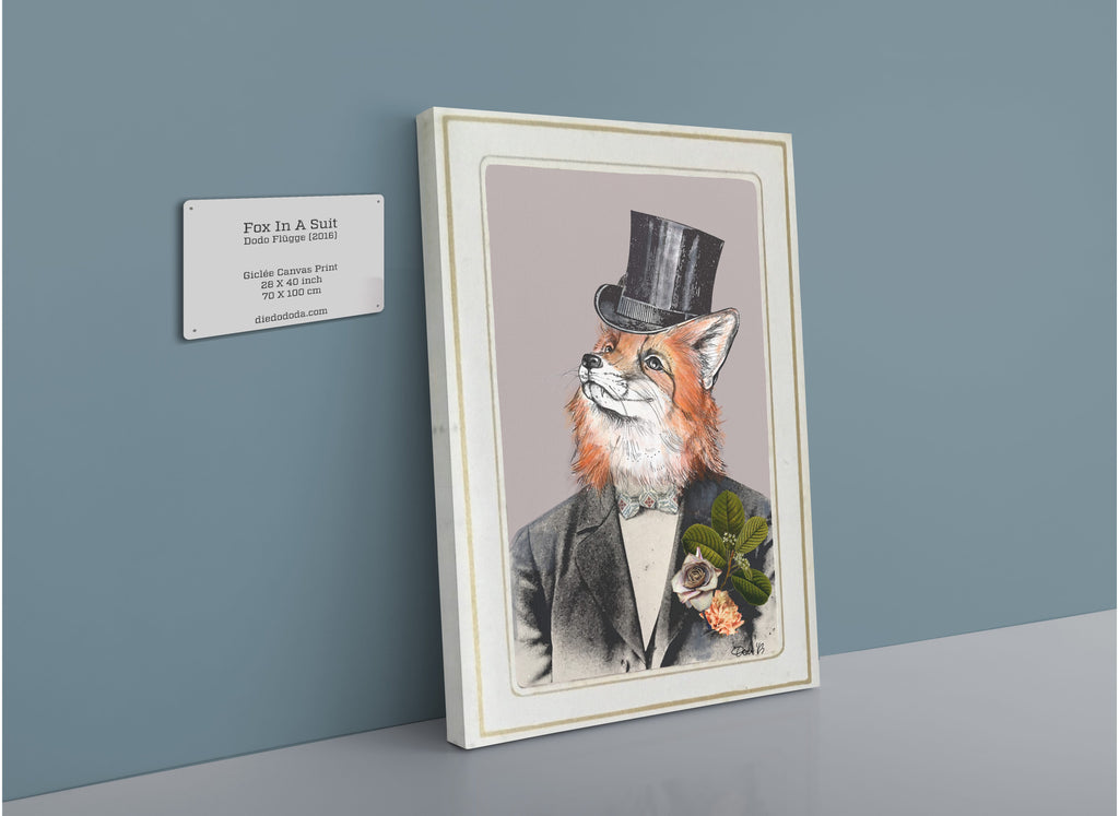 A Fox In A Suit Canvas Print by Animals In Suits hangs on a blue wall beside a plaque detailing the artwork and artist, lending the space an atmosphere reminiscent of vintage botanical art.