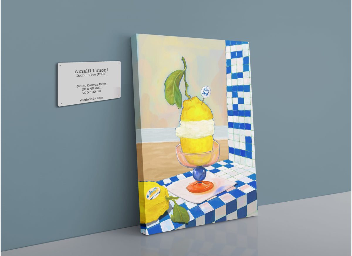 The Hôtel Dodo Amalfi Limoni Giclée Canvas Print, featuring a vibrant depiction of a lemon sorbet dessert in a glass dish, is showcased alongside a wall plaque detailing the artwork—all set on a blue and white tiled surface inspired by the Mediterranean elegance of the Amalfi Coast.