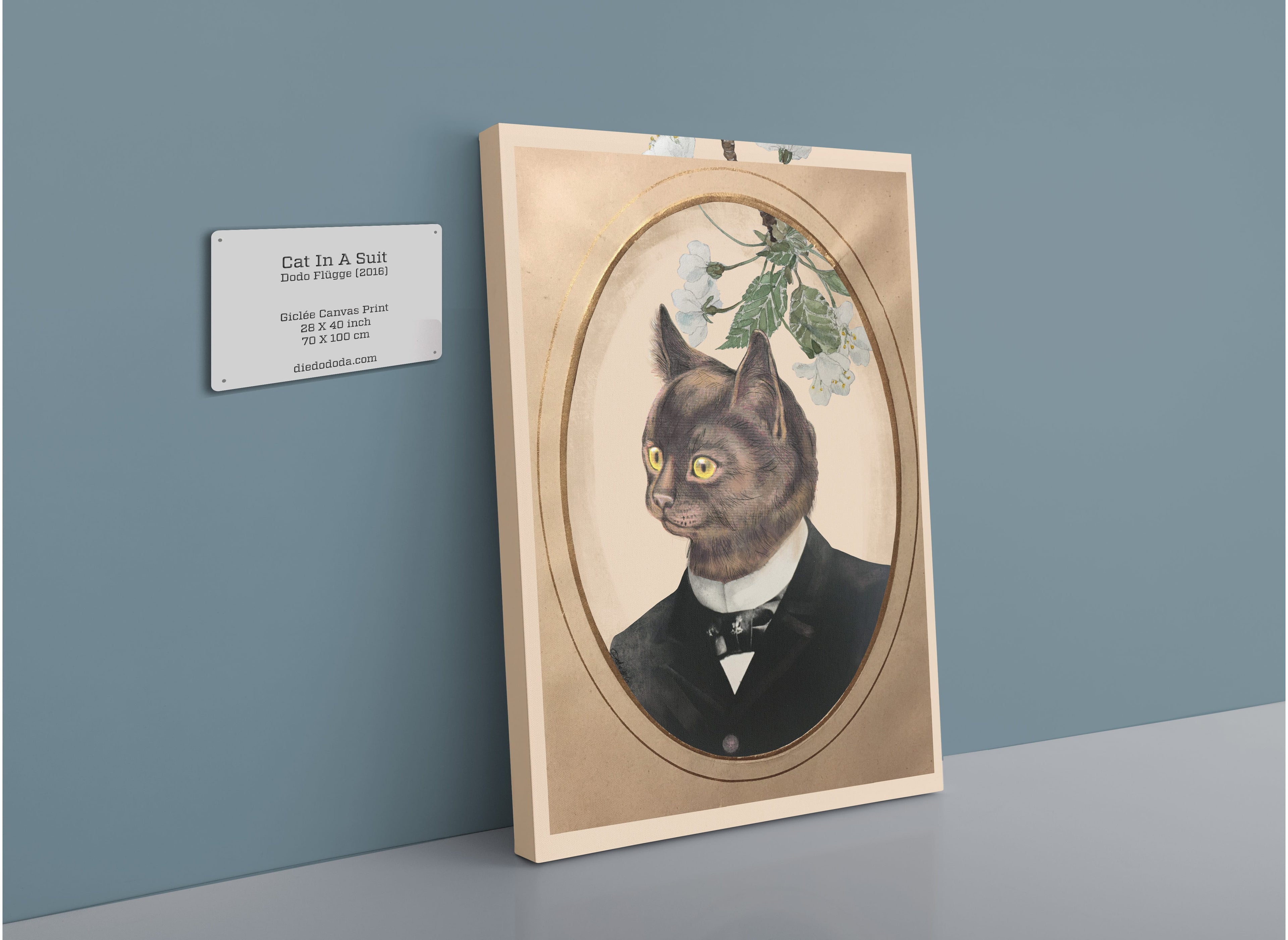 The Cat In A Suit Canvas Print by Animals In Suits showcases a charming cat dressed in a black suit and bow tie, elegantly framed and displayed on the wall with a plaque labeled “Cat In A Suit” accompanied by artwork details. This whimsical canvas print fuses classic portraiture with playful feline collage accents, providing a modern interpretation inspired by vintage botanical illustration styles.