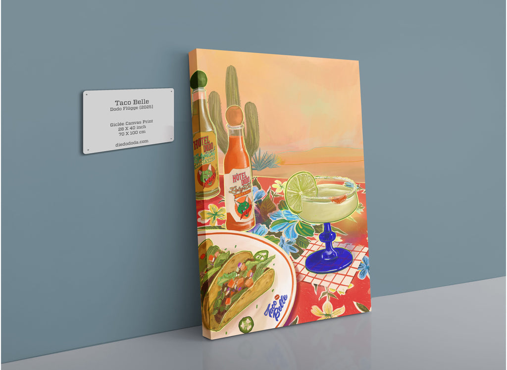 A vibrant Taco Belle Giclée Canvas Print by Hôtel Dodo, featuring crunchy tacos, a zesty margarita, Bodega Cat Hot Sauce, and cacti arranged on a table with a descriptive plaque on the wall beside it.