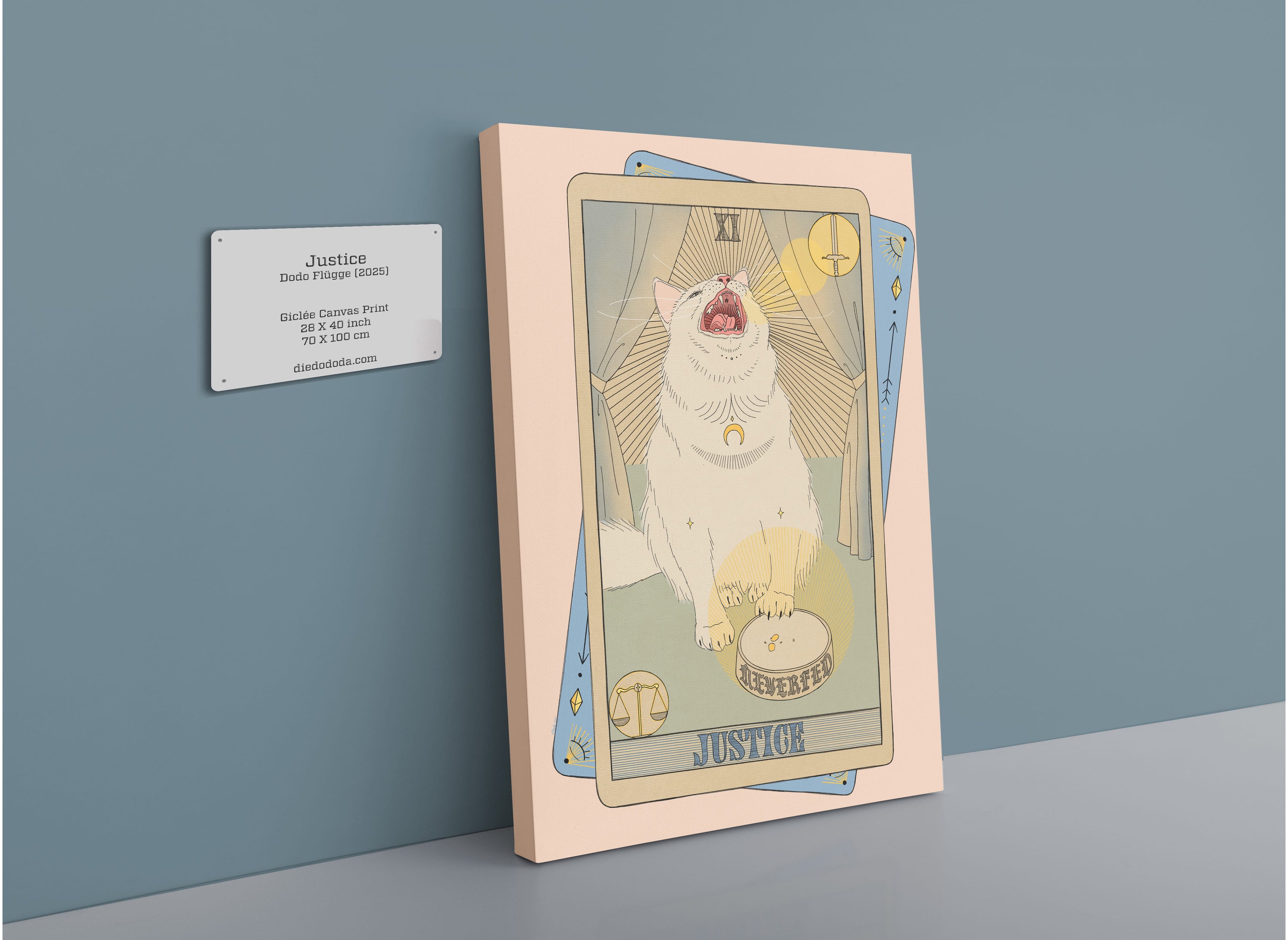 The Justice Canvas Print by Tarot Cats features framed artwork of a white cat illustrated as The Justice tarot card, inspired by the sign of Libra and the influence of Venus, displayed on a wall beside an informational plaque.