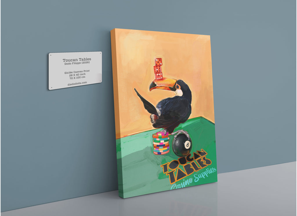 A Toucan Tables Giclée Canvas Print by Hôtel Dodo, featuring a toucan balancing poker chips and dice, pictured leaning against a blue wall with a label showing artwork details and dimensions.