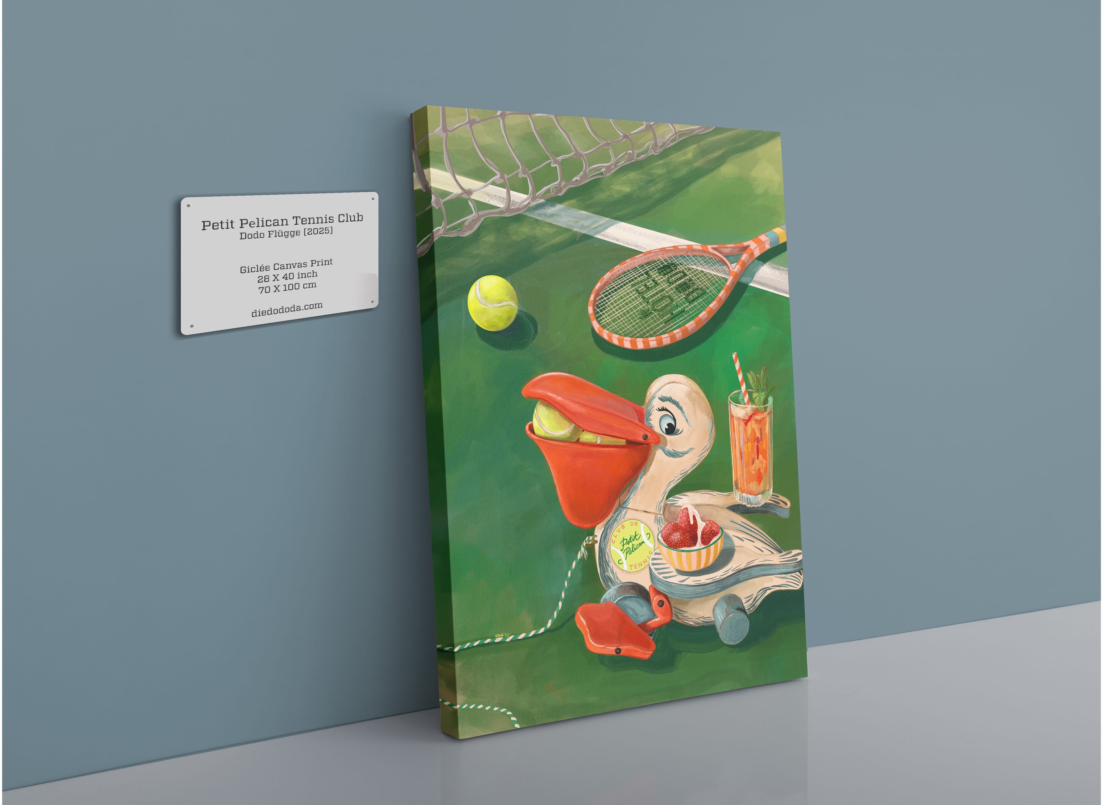 The Petit Pélican Tennis Club Giclée Canvas Print by Hôtel Dodo features a whimsical cartoon pelican on a tennis court, surrounded by a racket, tennis ball, Pimm’s and lemonade, strawberries and cream—capturing the quintessential charm of a classic tennis club. Beside the artwork is a wall plaque displaying its title and details.