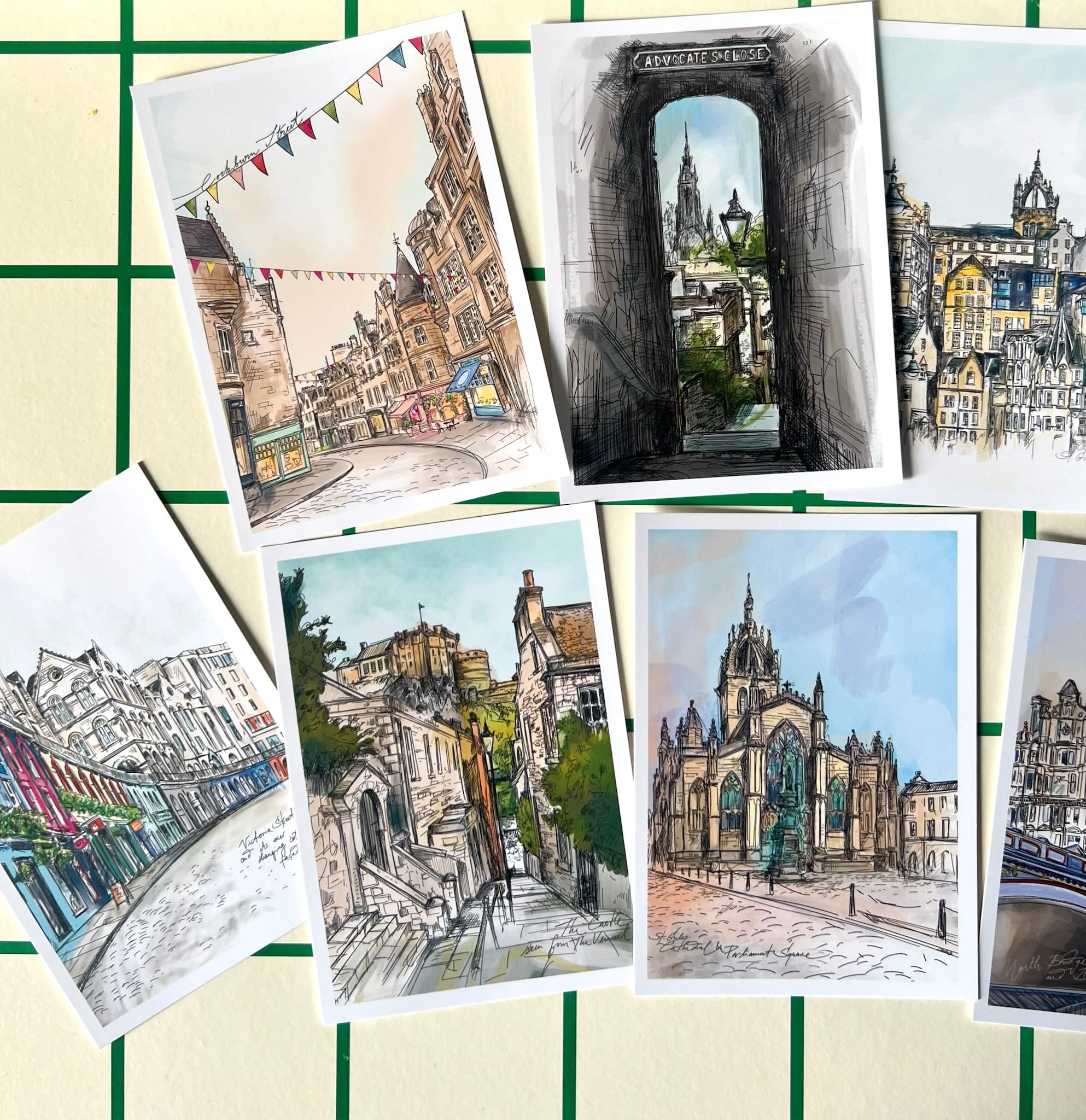 The Edinburgh Mini Print Set by Essential Edinburgh features 15 A6 original city scene drawings—streets, historic buildings, and landmarks—arranged on a grid background, making it an ideal souvenir or Scotland gift.