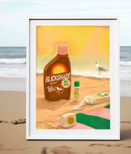 The Screen Queen Giclée Art Print by Hôtel Dodo features sunscreen products and a sea gull on a sandy beach with ocean waves in the background, beautifully framed and propped up on the shore.