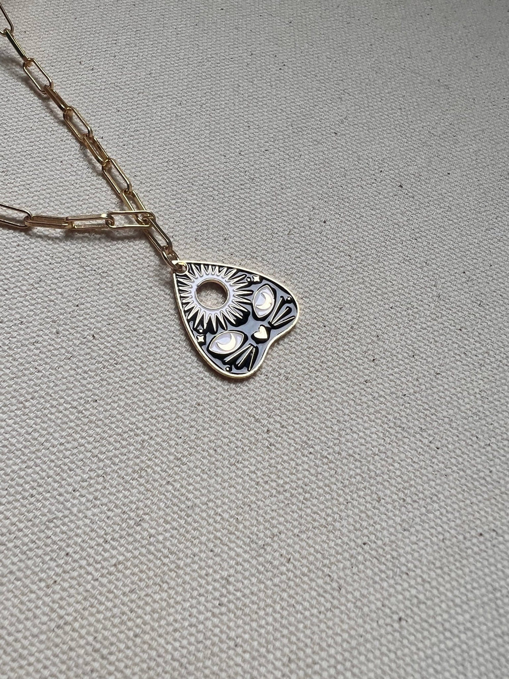 Ouija Kitty necklace with a heart-shaped pendant featuring a sunflower design on a paperclip chain by Necklaces.