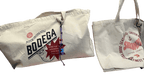 The Bodega/Shromp’s XXL Snack Shopper by Bags by diedododa includes two UK-made, eco-friendly cotton totes: one with a Bodega and cat design, the other seafood-themed with "Shrimp." Both are stylish and sustainable choices.