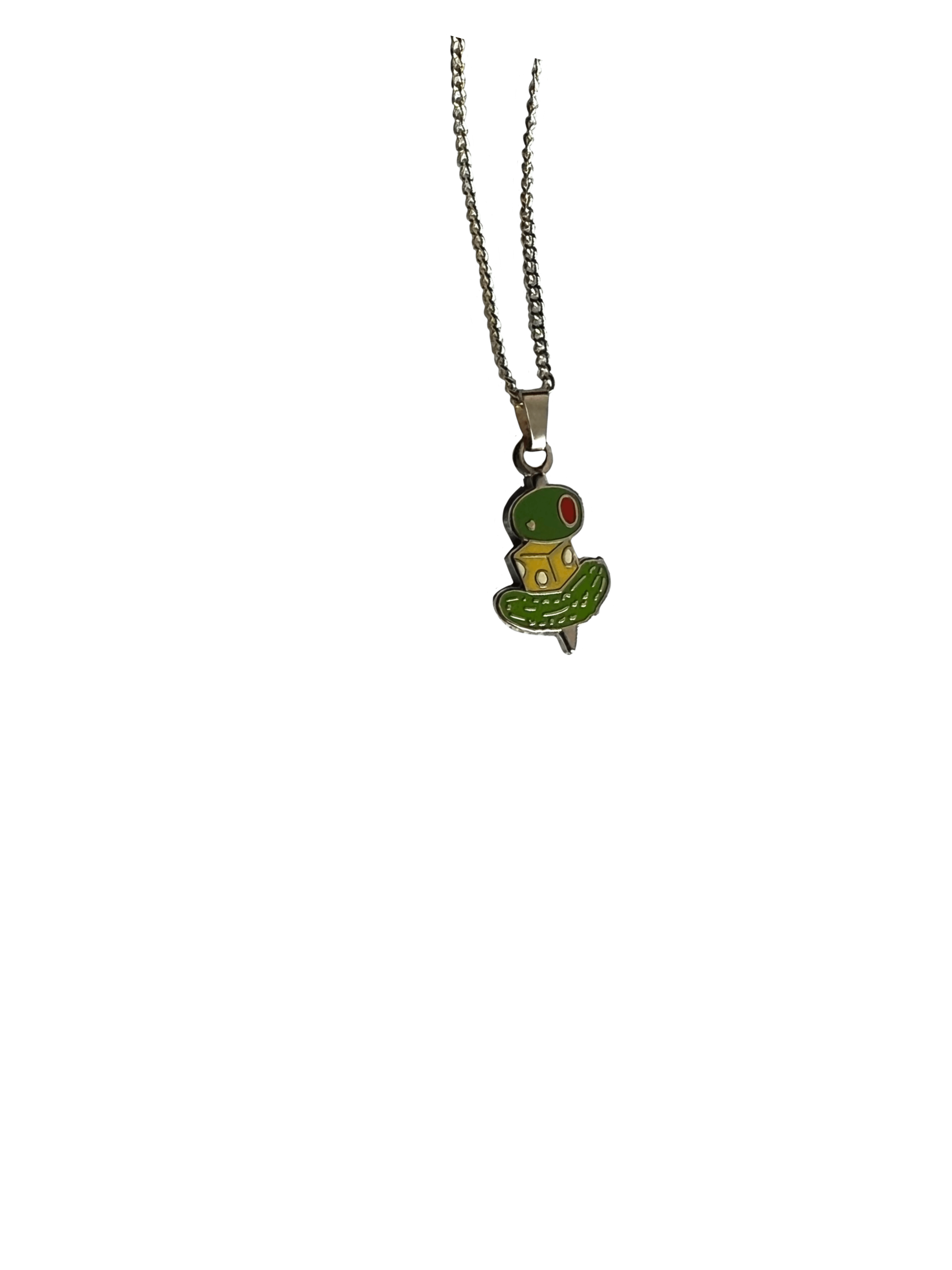The Canapé Cutie Necklace by Necklaces features a silver chain with a pendant shaped like a green cartoon alien in a flying saucer.