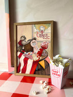 The Coconut Shy Cirque Du Dodo Giclée Art Print by Hôtel Dodo features a raccoon against a circus backdrop, with popcorn scattered on a red and white table, capturing vintage funfair charm.