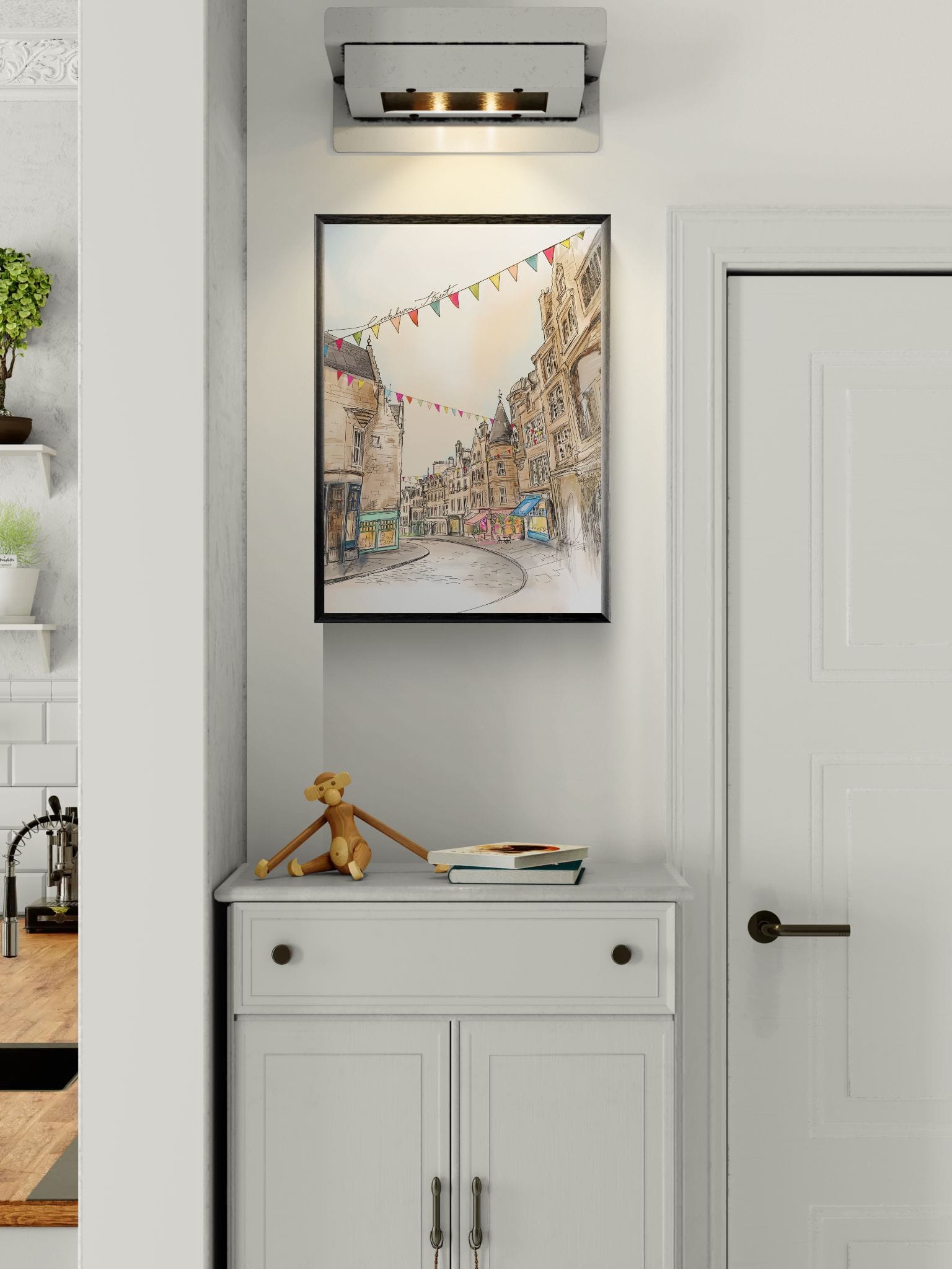 The Cockburn Street Edinburgh Matte Art Print by Essential Edinburgh hangs above a white cabinet with a teddy bear and closed notebook, alongside a door that brings to mind the charm and indie shops of Old Town.