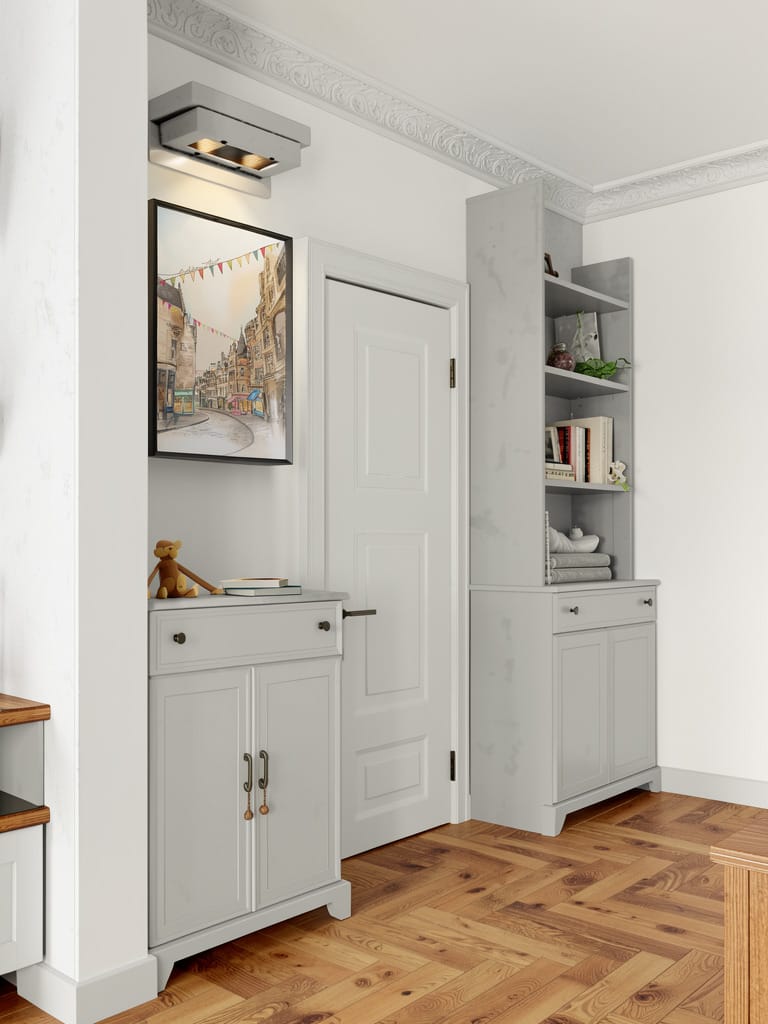 A small entryway inspired by Edinburgh Old Town features light gray cabinets, a white door, wood flooring, shelves with books and decor from indie shops on Cockburn Street, and the Cockburn Street Edinburgh Matte Art Print by Essential Edinburgh above a cabinet.