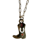 The Tiny Tootin Bootin Necklace by Necklaces features a silver horseshoe with a cowboy boot pendant, highlighted by red accents and 18k gold plating.