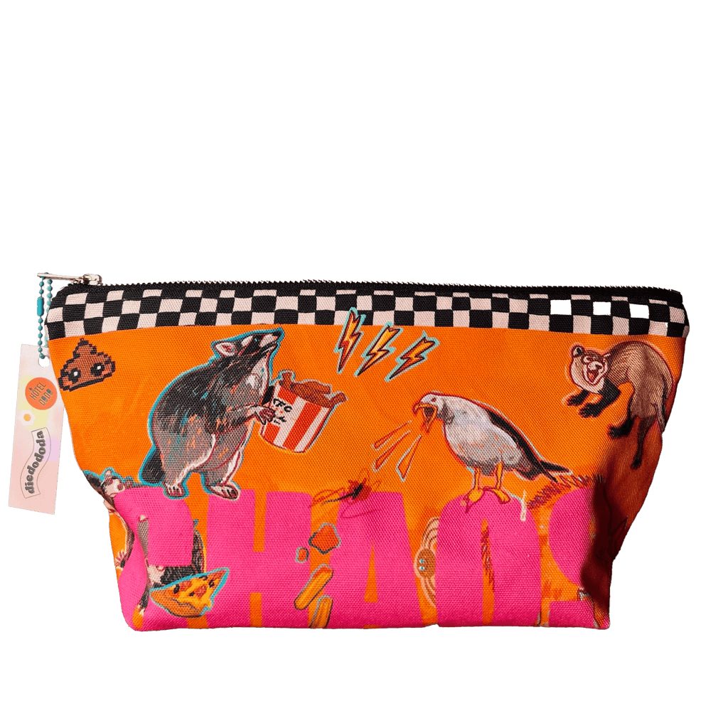 The Chaos Creatures Pouch by Aventures Des Créatures is an orange cotton organiser with a black-and-white checkered trim, colorful cartoon animal designs, and "CHAOS" in large pink letters—handmade in the UK.