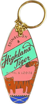 Introducing the Highland Tiger Hotel Keyring Light by Essential Edinburgh—a retro-style keyring that reads “Edinburgh Highland Tiger Hotel & Lodge” and showcases an illustrated tiger. Finished with an enamel tag, it doubles as a bag charm or distinctive keepsake.
