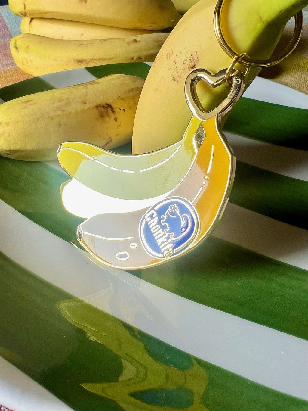 The Hôtel Dodo Chonkita Banana Keyring features a fun "Chomp Chomp" logo, ideal as a playful bag charm or keyring—a quirky accessory that brings Chonkita style to your everyday essentials.