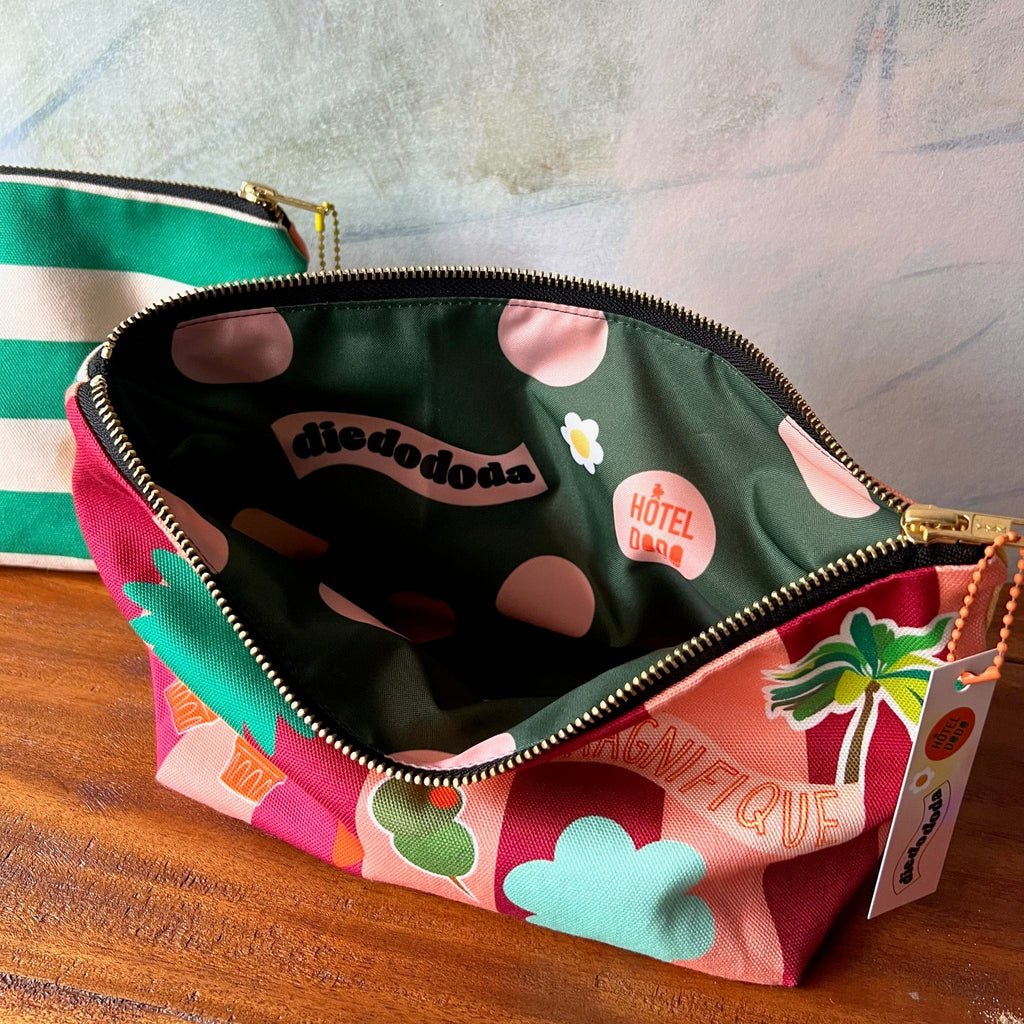 A colorful Patch Pick ‘n’ Mix Pouch by Hôtel Dodo with a patterned "diedododa" and "Hôtel du Pin" interior sits open on wood, beside another unique, handmade UK organiser pouch.