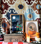 Spice up your Halloween décor with the Grumpy Spiced Pumpkin Giclée Art Print by Kitsch Kanaveral—an eye-catching display piece that pairs perfectly with candles, potion bottles, and pumpkins for classic horror-inspired vibes.