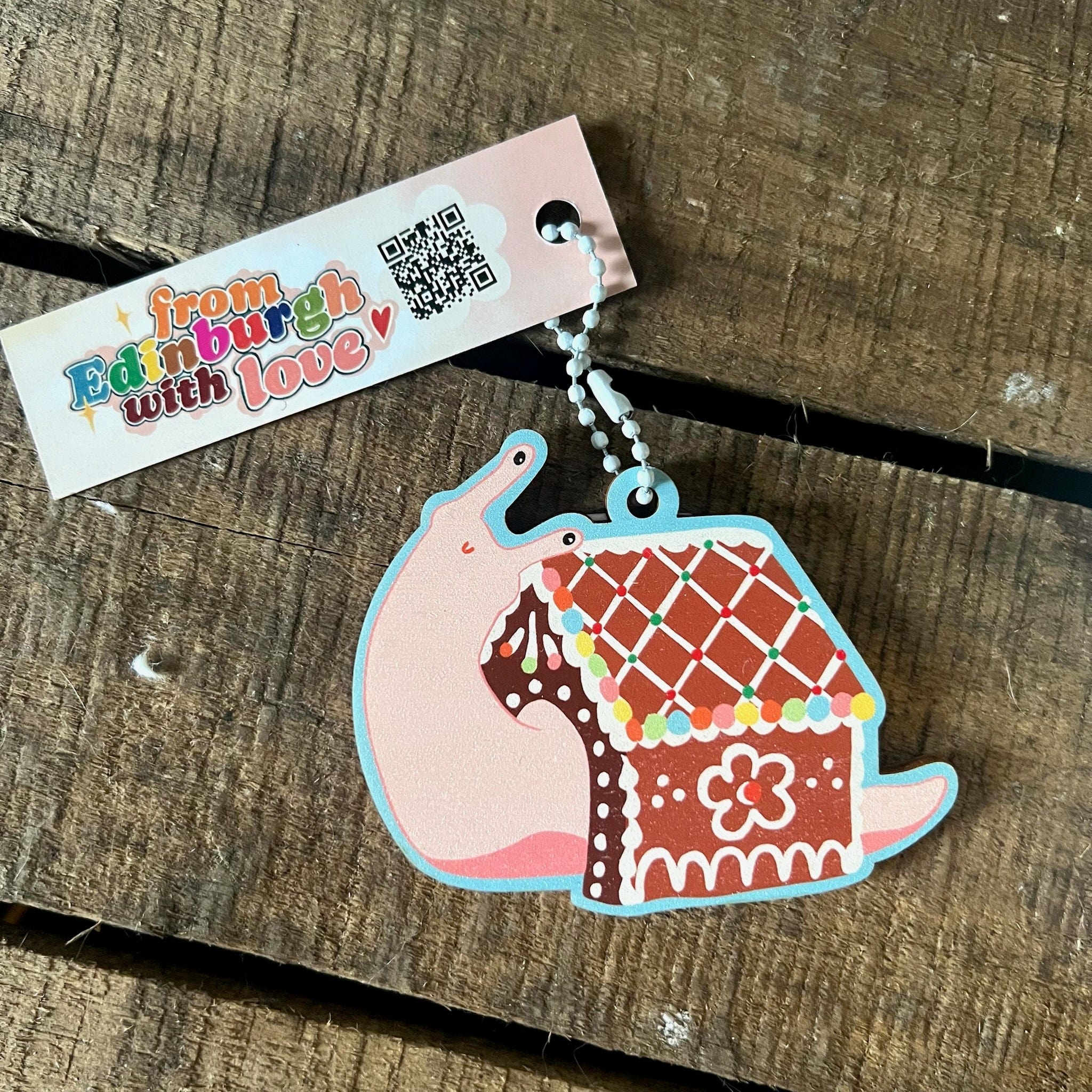 The Snail House Hanging Decoration by Christmas by diedododa features a cartoon snail with a gingerbread house shell and a 