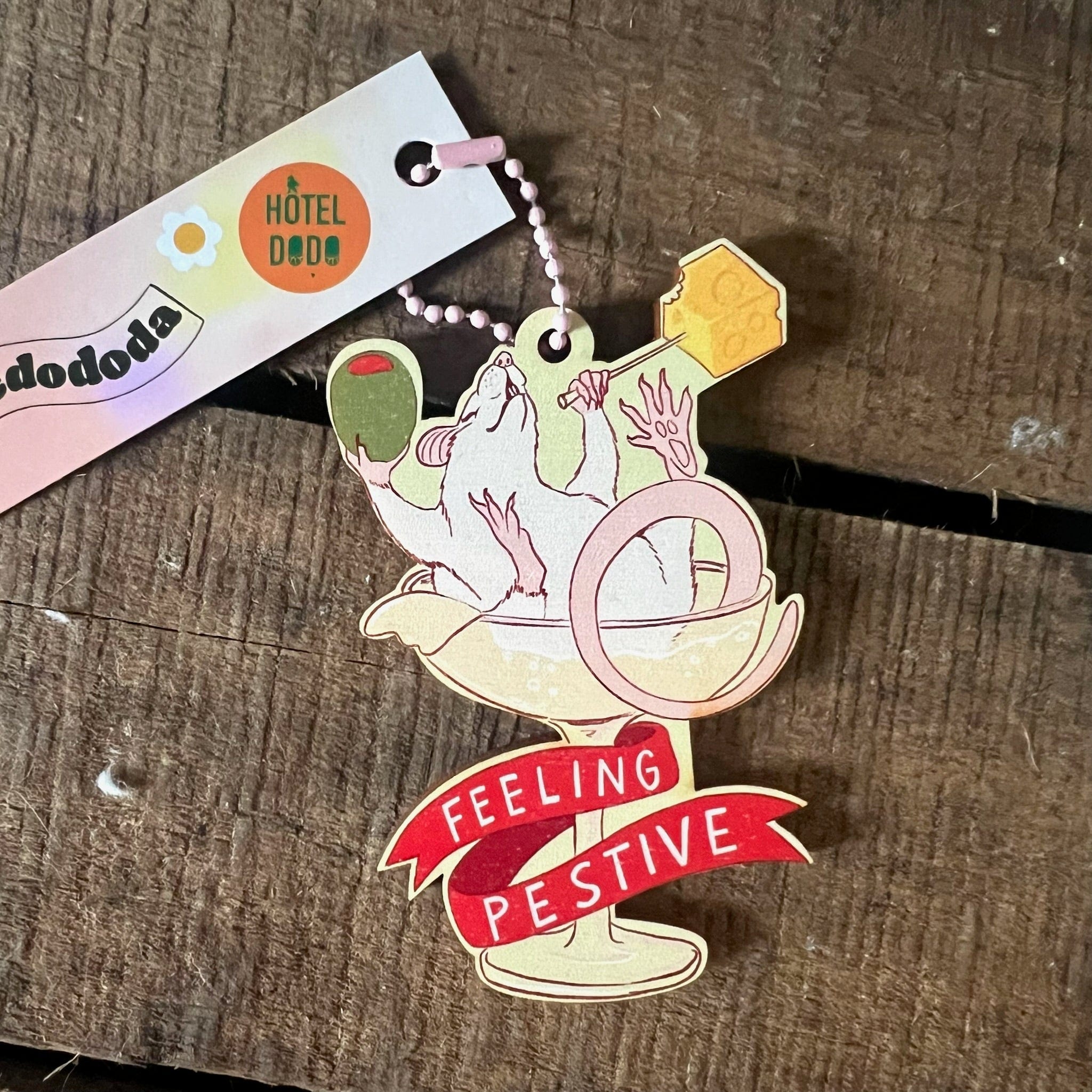 The Feeling Pestive Hanging Decoration by Christmas by diedododa features a rat lounging in a cocktail glass with an olive, a 