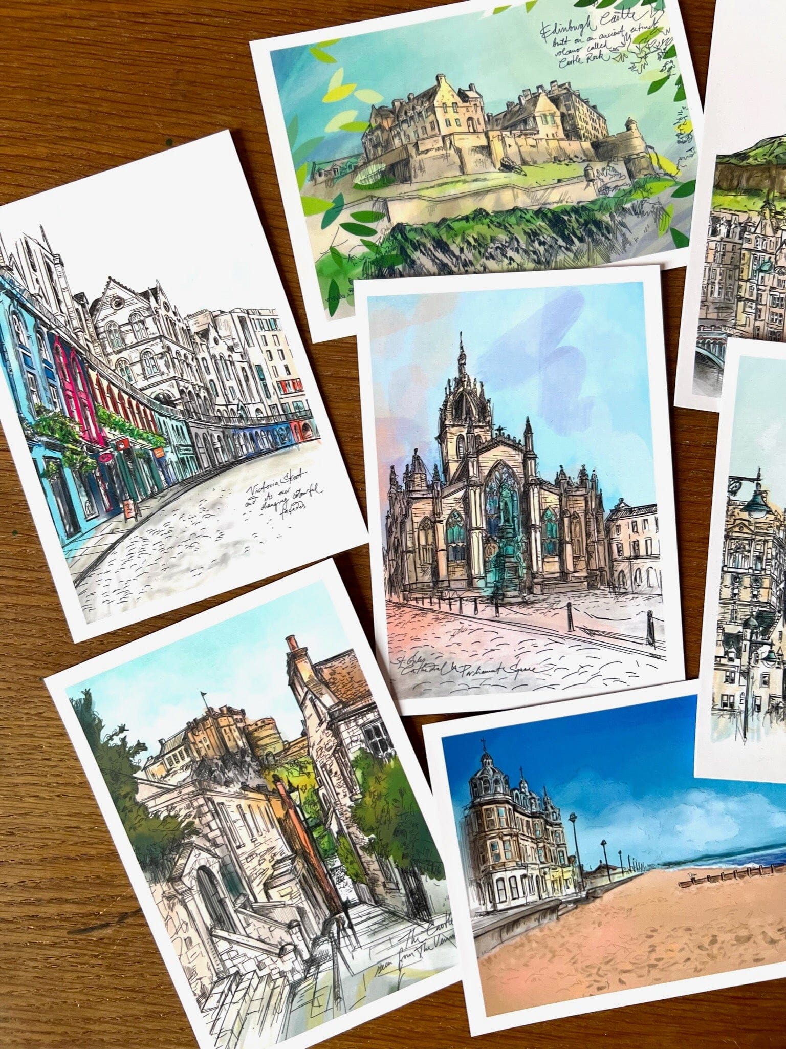 The Enchanting Edinburgh Mini Art Print Set by Essential Edinburgh features vibrant illustrations of iconic city landmarks, beautifully arranged—making it a perfect and unique souvenir gift.